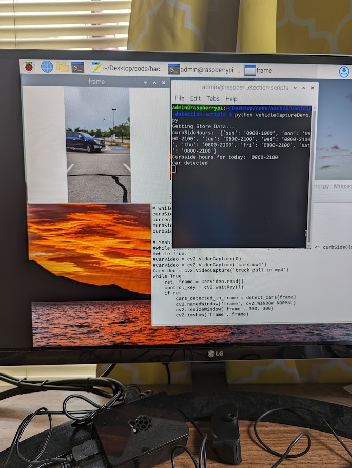 Vehicle-detection code and camera feed running on a monitor, showing curbside hours and a detected car